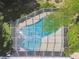 Aerial view of a private screened in pool surrounded by trees and foliage at 1402 E Mimosa Dr, Plant City, FL 33563