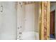 Tiled shower and tub enclosure featuring neutral tiles and a shower head, offering a clean and functional space at 1402 E Mimosa Dr, Plant City, FL 33563