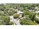 Idyllic aerial shot of the property nestled within a tranquil, tree-filled community near a shimmering lake at 14619 Daybreak Dr, Lutz, FL 33559