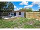 Backyard featuring new fence, patio and well-maintained lawn at 14619 Daybreak Dr, Lutz, FL 33559