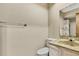 Bathroom featuring a white toilet, beige sink, and a mirror at 14619 Daybreak Dr, Lutz, FL 33559