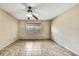 Bedroom with tile flooring, ceiling fan, and a window overlooking the yard at 14619 Daybreak Dr, Lutz, FL 33559