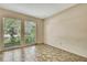 Bedroom with tile flooring and two windows overlooking the lush backyard at 14619 Daybreak Dr, Lutz, FL 33559