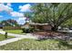 Well-kept front yard with large shade tree covering home at 14619 Daybreak Dr, Lutz, FL 33559