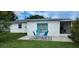 Charming backyard patio with seating for relaxation, set against a backdrop of lush green grass at 1583 Eunice Ln, Clearwater, FL 33756