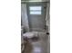 Well-lit bathroom featuring an updated shower, tile, and tub featuring white shower curtain at 1583 Eunice Ln, Clearwater, FL 33756