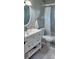Charming bathroom with a white vanity, updated sink, and tiled shower with a stylish curtain at 1583 Eunice Ln, Clearwater, FL 33756
