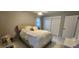 Bright bedroom features a well-lit space, neutral colors, tile floor, and a double-door closet at 1583 Eunice Ln, Clearwater, FL 33756