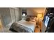 Stylish bedroom featuring modern design, patterned bedding, a side table lamp, and a double-door closet at 1583 Eunice Ln, Clearwater, FL 33756