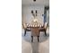 Bright dining area featuring a modern chandelier, marble floors, and views into other rooms at 1583 Eunice Ln, Clearwater, FL 33756