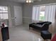 Bright living room with a plush chaise lounge, modern finishes, and abundant natural light at 1583 Eunice Ln, Clearwater, FL 33756