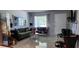 Stylish living room featuring bright walls, elegant marble floors, and floral-patterned furniture at 1583 Eunice Ln, Clearwater, FL 33756