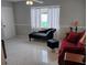Comfortable living room featuring a chaise lounge, stylish sofa, and large windows for natural light at 1583 Eunice Ln, Clearwater, FL 33756