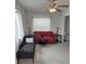 Elegant living room showcasing a stylish red sofa and luxurious decor with a ceiling fan at 1583 Eunice Ln, Clearwater, FL 33756