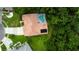 Aerial view showcases property with screened-in pool and lush landscaping, creating a private oasis at 1827 Foxboro Ct, Oldsmar, FL 34677