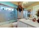 Bathroom featuring a bathtub, tiled walls, and a vanity with a sink and storage at 1827 Foxboro Ct, Oldsmar, FL 34677