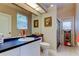 Well-lit bathroom featuring a blue countertop vanity, framed mirror, and glass-enclosed shower at 1827 Foxboro Ct, Oldsmar, FL 34677
