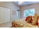 Bright bedroom featuring a ceiling fan, closet, and large window at 1827 Foxboro Ct, Oldsmar, FL 34677