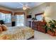 Spacious bedroom featuring a ceiling fan, large dresser, and access to outdoor pool area at 1827 Foxboro Ct, Oldsmar, FL 34677