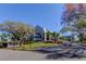 Clubhouse entrance with manicured landscaping and American flag at 1827 Foxboro Ct, Oldsmar, FL 34677