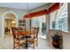 Bright dining area with a round table and chairs, with a view of the outdoor patio through sliding glass doors at 1827 Foxboro Ct, Oldsmar, FL 34677