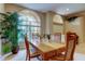 Cozy dining room with a wooden table, surrounded by two arched windows and a large potted plant at 1827 Foxboro Ct, Oldsmar, FL 34677