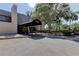Clubhouse entrance with covered awning, tropical trees and plantings at 1827 Foxboro Ct, Oldsmar, FL 34677