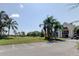 Well-maintained lush green lawn, parking and clubhouse exterior at 1827 Foxboro Ct, Oldsmar, FL 34677