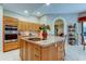 Spacious kitchen features a central island with cooktop and ample counter space at 1827 Foxboro Ct, Oldsmar, FL 34677