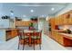 Well-lit kitchen with an island, wraparound counters, and tile flooring at 1827 Foxboro Ct, Oldsmar, FL 34677