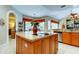 Spacious kitchen featuring an island with a cooktop and ample cabinet space at 1827 Foxboro Ct, Oldsmar, FL 34677