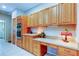 Kitchen area featuring built-in ovens, wooden cabinets, and light countertops at 1827 Foxboro Ct, Oldsmar, FL 34677