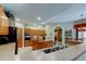 Well-lit kitchen with island, stainless appliances, and seamless transition to dining area at 1827 Foxboro Ct, Oldsmar, FL 34677