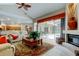 Cozy living room showcases an inviting layout, fireplace, and seamless access to an outdoor space at 1827 Foxboro Ct, Oldsmar, FL 34677