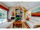 Inviting living room features a cozy fireplace, custom shelving, and access to the screened-in patio with a pool at 1827 Foxboro Ct, Oldsmar, FL 34677