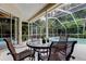 A cozy screened patio features seating, a ceiling fan, and access to a relaxing pool and spa at 1827 Foxboro Ct, Oldsmar, FL 34677