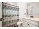 Bathroom with vanity, decorative shower curtain, and wood-look flooring at 19209 Long Lake Ranch Blvd, Lutz, FL 33558