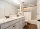 Bathroom with double sinks with granite counters, wood cabinets, and shower and tub combo at 19209 Long Lake Ranch Blvd, Lutz, FL 33558