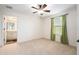 Bedroom with carpet flooring, a ceiling fan, and a window with green curtains at 19209 Long Lake Ranch Blvd, Lutz, FL 33558
