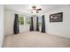 Bedroom featuring natural light from two windows, a ceiling fan, and neutral carpet at 19209 Long Lake Ranch Blvd, Lutz, FL 33558