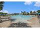 Community pool features shallow entry, a central water fountain, and is surrounded by lounge chairs and shaded seating areas at 19209 Long Lake Ranch Blvd, Lutz, FL 33558