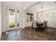 Elegant dining room with wood floors, chandelier, and a view through the decorative glass front door at 19209 Long Lake Ranch Blvd, Lutz, FL 33558