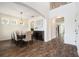 Elegant dining area with hardwood floors, chandelier, and an arched doorway to other living spaces at 19209 Long Lake Ranch Blvd, Lutz, FL 33558