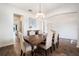Dining area showcasing hardwood floors, an elegant chandelier, and an arched doorway to the kitchen at 19209 Long Lake Ranch Blvd, Lutz, FL 33558