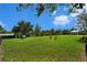 Community dog park featuring a grassy area with agility equipment, surrounded by trees and fencing at 19209 Long Lake Ranch Blvd, Lutz, FL 33558