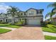 Attractive two-story home with manicured landscaping, brick driveway, and inviting curb appeal at 19209 Long Lake Ranch Blvd, Lutz, FL 33558