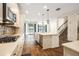 Bright kitchen with stainless steel appliances, center island, and wood-look flooring at 19209 Long Lake Ranch Blvd, Lutz, FL 33558