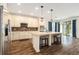 Bright kitchen with stainless steel appliances, backsplash, center island, and open floorplan at 19209 Long Lake Ranch Blvd, Lutz, FL 33558