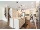 Bright kitchen with a large center island, pendant lighting, and stainless steel appliances at 19209 Long Lake Ranch Blvd, Lutz, FL 33558