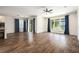Open-concept living area with hardwood floors, and lots of light from the large sliding glass doors at 19209 Long Lake Ranch Blvd, Lutz, FL 33558